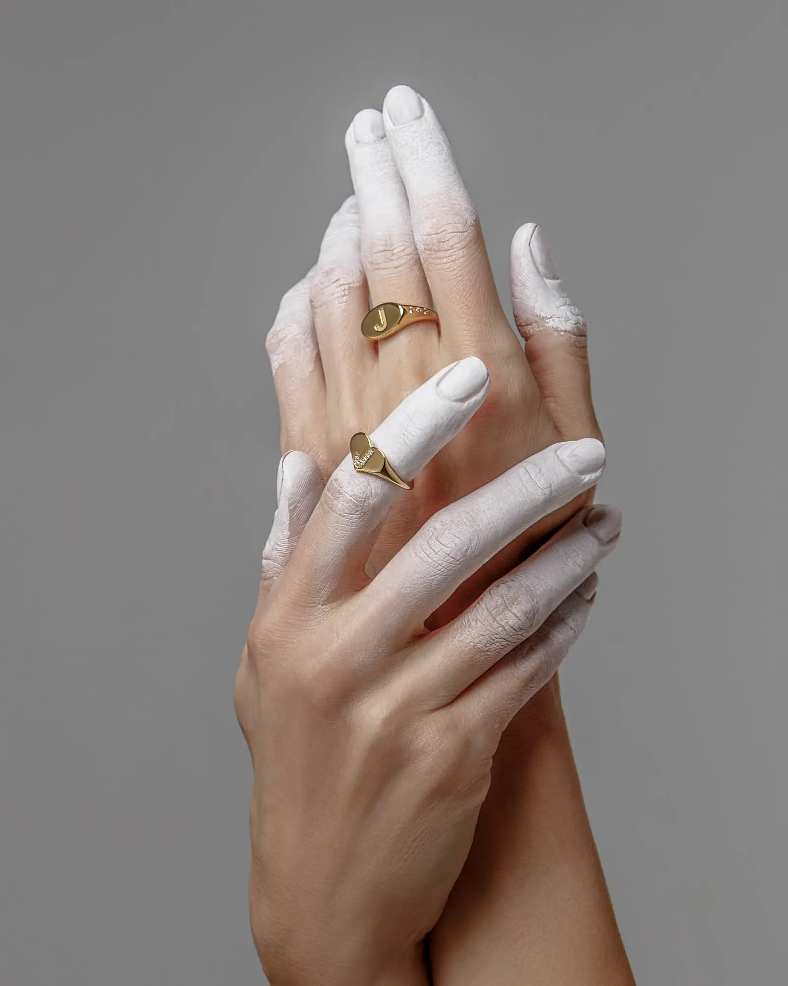 Gold signet rings in close-up on a hand
