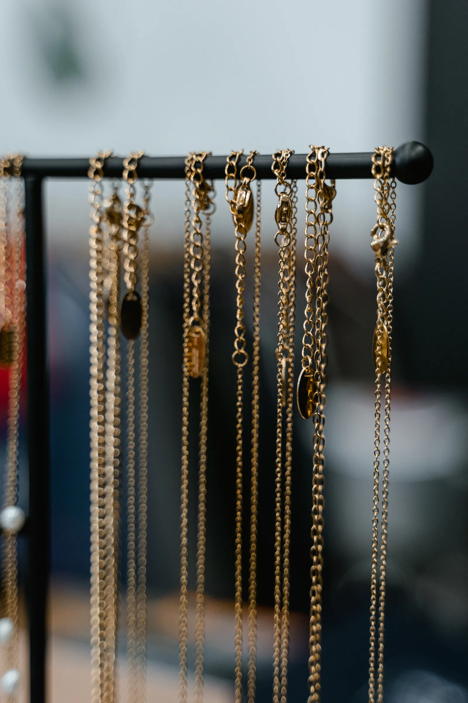 Gold chains and necklaces hanging in a jeweler's display